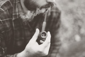 a man smoking with weed pipe