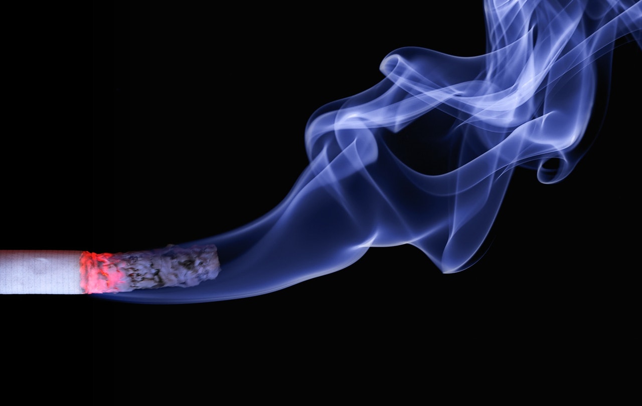 half-burnt cigarette with smoke